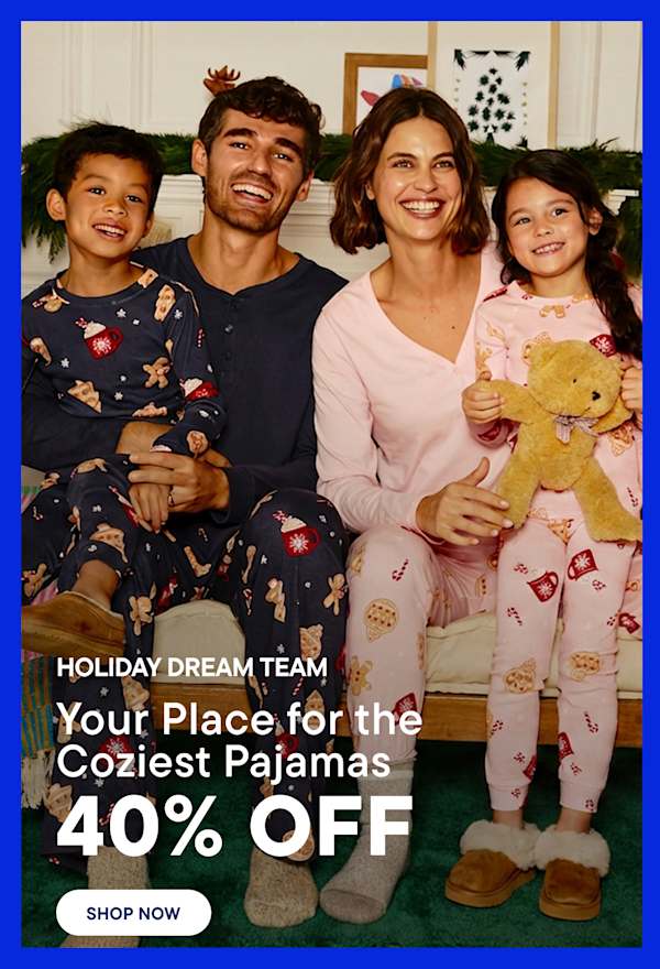 A smiling family in matching pajamas sits on a white cushion in the foreground, with a decorated Christmas tree and a yellow armchair in the background.
