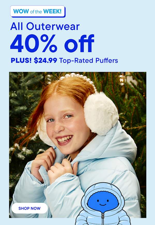 A smiling girl wearing a light blue puffer jacket and white earmuffs stands in the foreground against a background of green pine trees.