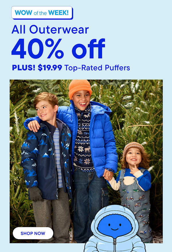 Three children wearing winter outerwear stand together in the foreground against a background of snowy evergreen trees.