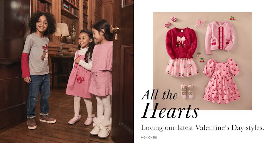 The image shows a group of people, likely a family, standing together in what appears to be a home setting, with a display of Valentine's Day-themed clothing and accessories in the background.