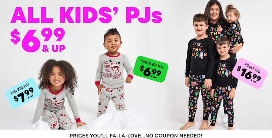 The image shows a group of people, likely friends or family, standing on a city street. They are wearing colorful, patterned clothing and appear to be shopping or browsing at a nearby store, as indicated by the price tags and signs in the foreground.